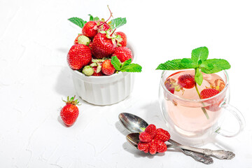 Strawberry tea concept. Good morning concept. Teapot, ripe fruits, healthy beverage
