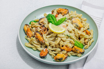 Plant based pasta with mussels, pesto and parmesan cheese. Ready to eat healthy food, served portion