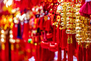 Traditional Chinese shinning golden souvenirs displayed at market gift stall in shopping...