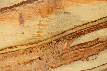 Natural rock texture background of multicolored sandstone rocks in the Almagreira beach in the Peniche area of the Center region of Portugal.