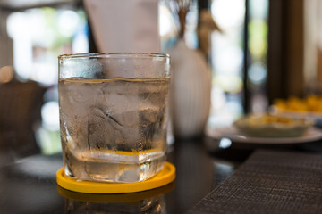 Glass of ice water in table. Refreshing drink on hot days