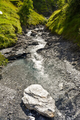 Water flowing on a stream in the rocky mountains  of the swiss alps