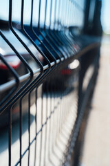 Car parking behind the fence. Close-up