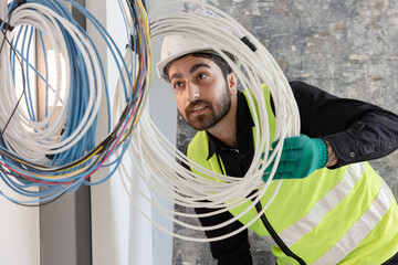 electrical engineers or technicians is professionally inspecting the wiring and systems in the building. Check electrical equipment to meet safety standards. Use a tablet to check buildings.