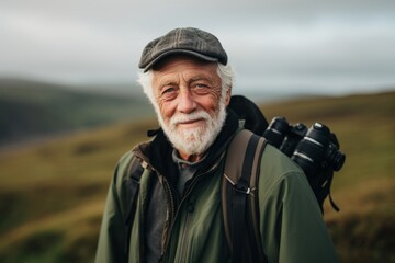 Portrait of senior man with a backpack and binoculars.