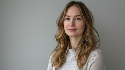 Fototapeta premium Happy attractive confident young adult or mid aged European woman posing for beauty aesthetic portrait. Beautiful lady smiling on background, attractive female model looking at camera. Close up face .