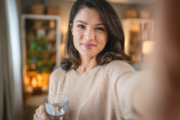 one woman beautiful adult female at home with glass of water
