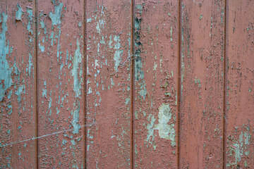 weathered peeling brown paint on a wooden wall