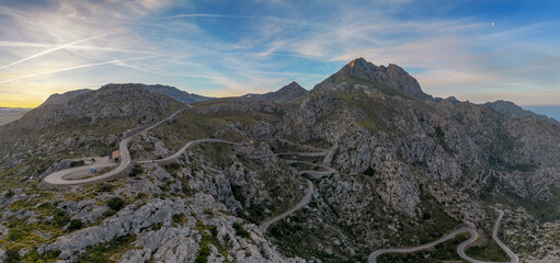 view of the famous snake road leading from the Coll de Reis mountain pass to Sa Calobra in the rugged landscape of northern Mallorca - obrazy, fototapety, plakaty