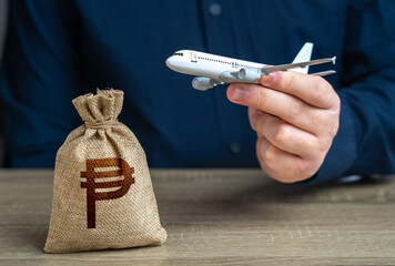 Airplane flights and philippine peso money bag. Airline industry income. Budget allocations....