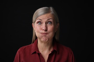 Personality concept. Portrait of emotional woman on black background