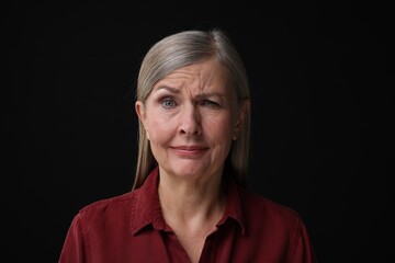 Personality concept. Portrait of woman winking on black background