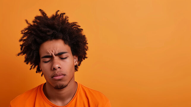 Latino Afro-American Man Expressing Sadness And Grief, Isolated On Solid Background - Copy Space Provided