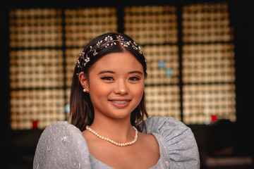 A beautiful radiant young Filipino woman in a modern baro’t saya traditional dress, posing...