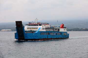 Ferries sail on the sea, ferries in the Bali Strait as a means of transportation between islands in...
