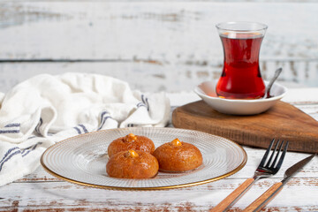Sekerpare or badempare dessert on a white wood background. Traditional Turkish cuisine flavors. ramadan dessert
