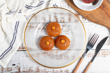 Sekerpare or badempare dessert on a white wood background. Traditional Turkish cuisine flavors. ramadan dessert