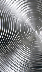 Monochrome silver spiral creating a hypnotic optical illusion.