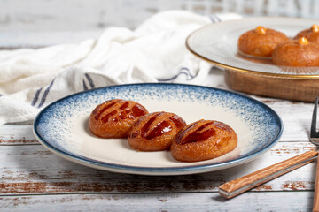 Sekerpare or badempare dessert on a white wood background. Traditional Turkish cuisine flavors. ramadan dessert