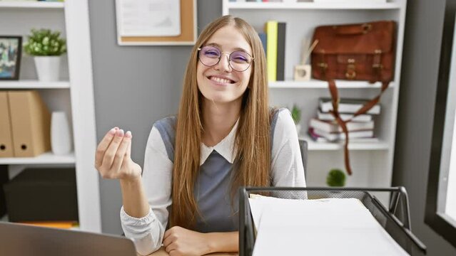 Cheerful young blonde businesswoman expressing confidence with italian hand gesture in the office