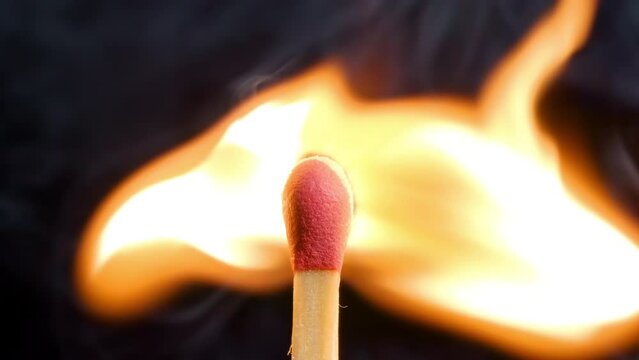 4K - Burning match in the wind. Close-up