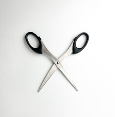 Stainless steel opened scissors with black colored handle. Cutting object photography isolated on...