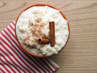 corn hominy, mungunz&aacute; typical Brazilian food in brown bowl with cinnamon and wooden background