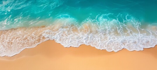 Fototapeta na wymiar Aerial view of coastal beach with crashing waves, blue water, foam, and sandy shoreline in summer