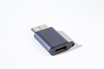 Isolated dark gray USB With HDD adapter on a white background.