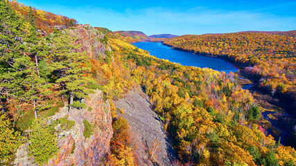 Aerial Autumn Splendor of Forested Landscape with Serene River in Michigan