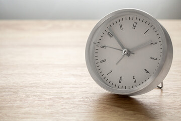 Silver alarm clock on wood table background