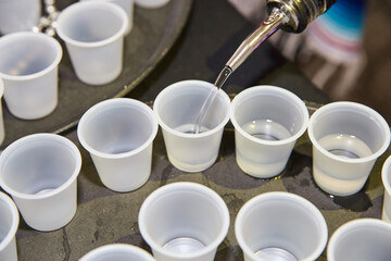 Pouring Beverage at Cinco de Mayo Party - Close-Up on Plastic Cups