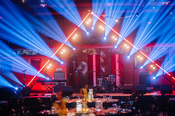 Fototapeta na wymiar Riga, Latvia - February 16, 2024 - a stage with musical instruments and a dynamic light show in a festive event setting.
