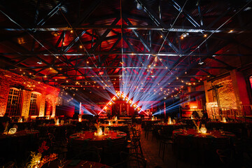 Riga, Latvia - February 16, 2024 - an event space with a vibrant light show, red ambient lighting,...