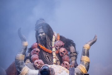 Masan Holi, Portrait of an male artist act as lord shiv with dry ash on face and body also in air...