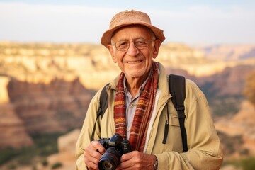 Senior tourist man with camera in Grand Canyon National Park, Arizona, USA