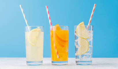 Various lemonade with ice in glasses