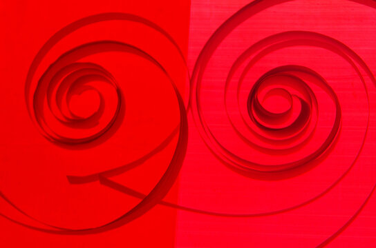 paper green ,red  spirl on coloured  background 