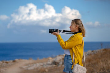 A woman photographer takes pictures of wildlife nature.