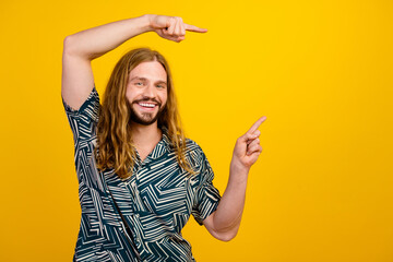 Photo of confident attractive guy wear print shirt showing two fingers empty space isolated yellow...