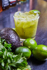 Fresh Green Cocktail with Lime and Avocado on Dark Surface