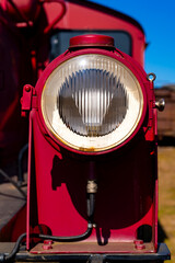 Red headlight lamp of a historic old diesel engine small shunting locomotive “Köf“ with...