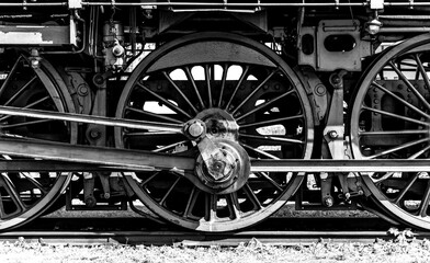 Huge driving wheels of an ancient german steam express train locomotive with cast iron and steel...