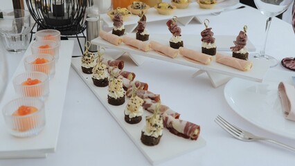 Buffet indoors. Catering business waiter. Catering on a banquet table with appetizers-canapes in a restaurant or hotel. Snacks on the table, catering concept.