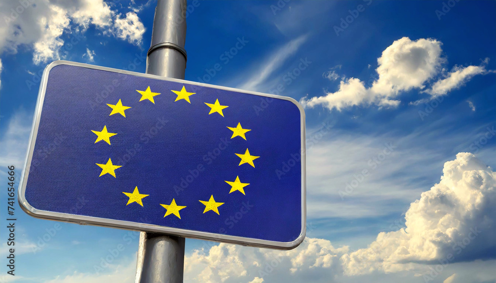 Wall mural closeup of a modern road sign with the european union flag on blue sky with clouds and copy space. g