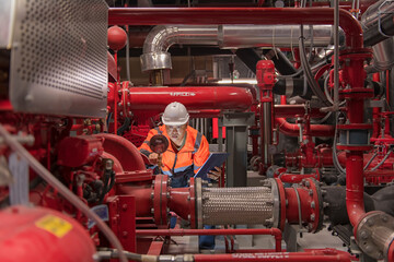 engineer checking and inspection pressure ,pipeline in fire pump room. High Pressure Water Pump...