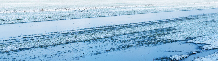 Partially flooded and frozen agricultural field