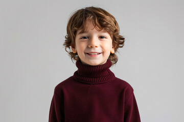 portrait of a child smiling with maroon color sweater for advertisement