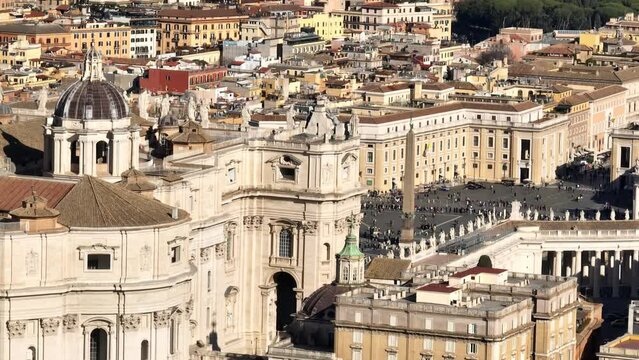 Aerial view of the colonnade and St. Peter's square located in the Vatican city. This state is an enclave within the city of Rome, Italy. The obelisk in the center is known as "The Witness".

