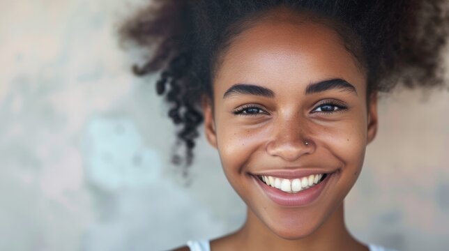 Attractive African American woman portrait. Pretty smiling black girl look camera. Happy mixed race person face. Young adult teenager. Cool stylish teen. Fashionable ethnic 20s student. Home indoor.